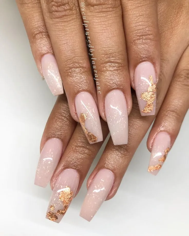 Acrylic Nail Designs for Every Skin Tone: Light, Medium, Tan & Dark 14 Nude acrylic nails with gold foil accents, glowing on tan-toned skin