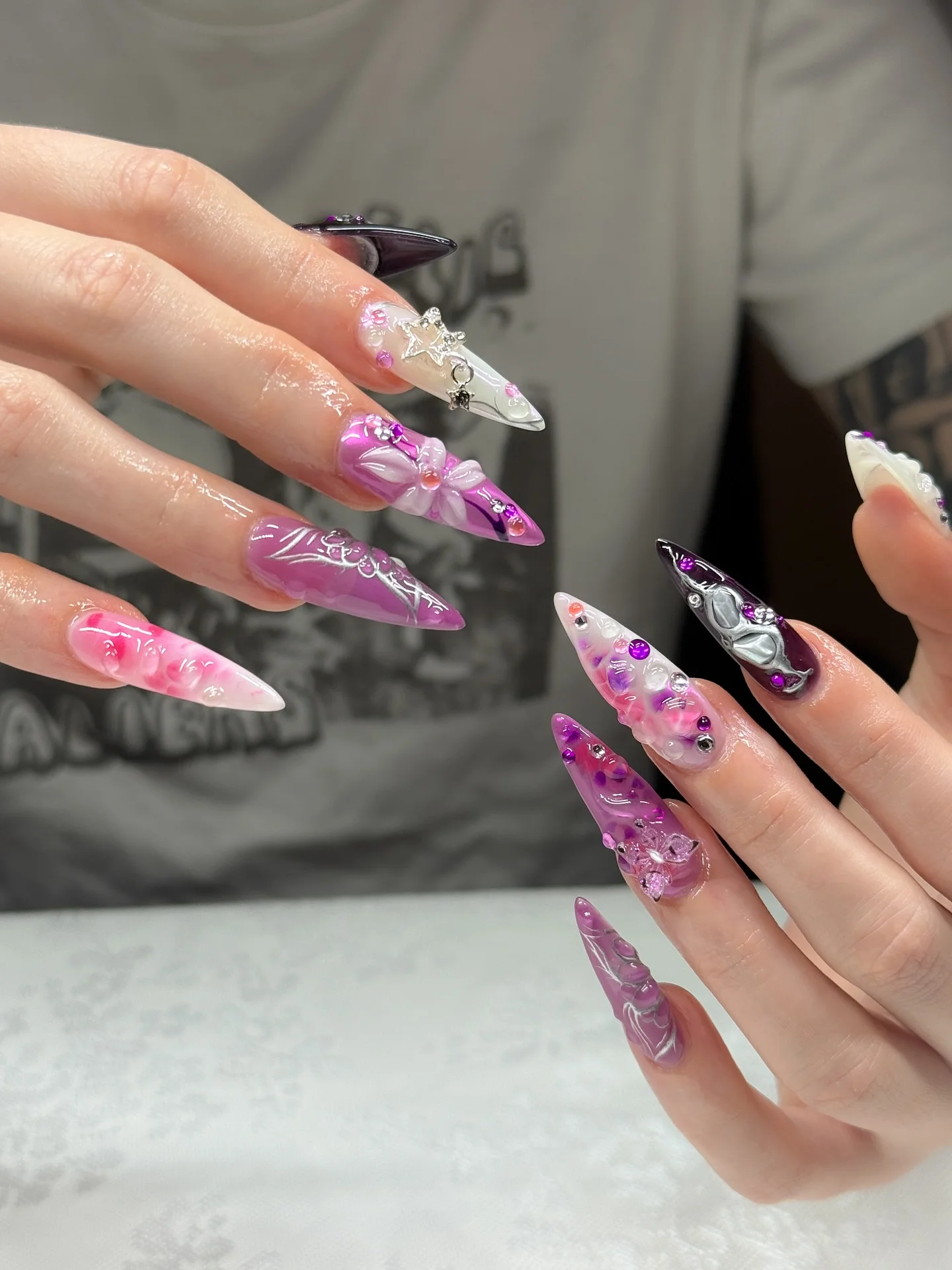 31 Nail Charm Ideas That Will Instantly Upgrade Your Nails in 2025 23 Stiletto acrylic nails with 3D bow, star charm and butterfly accents in pink and white
