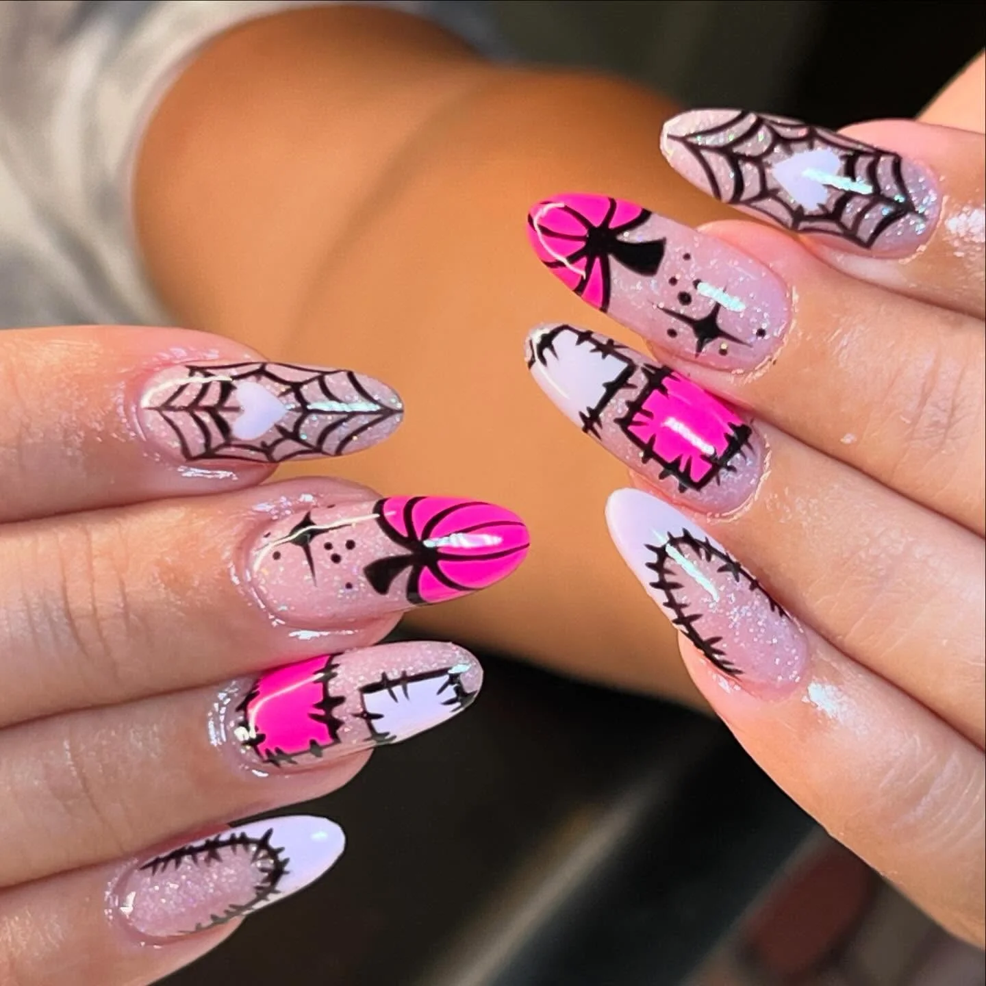 pink spiderweb pumpkin Halloween nails — girly pink halloween nail design 2026