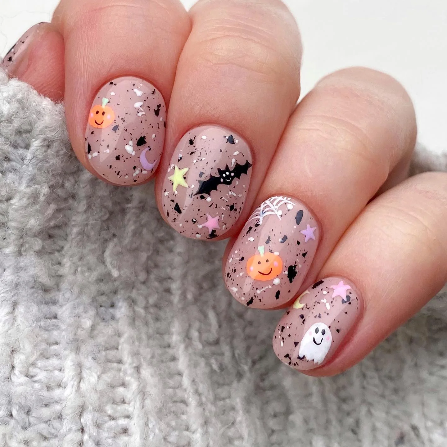speckled nude Halloween nails pastel pumpkins bats — soft halloween nail art 2026