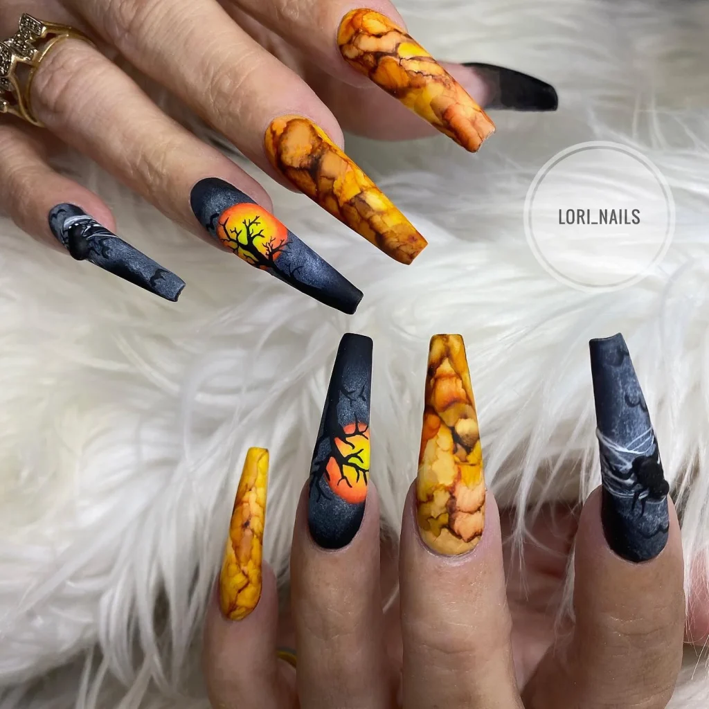 sunset web Halloween nails orange marble black trees — artistic halloween nail design 2026