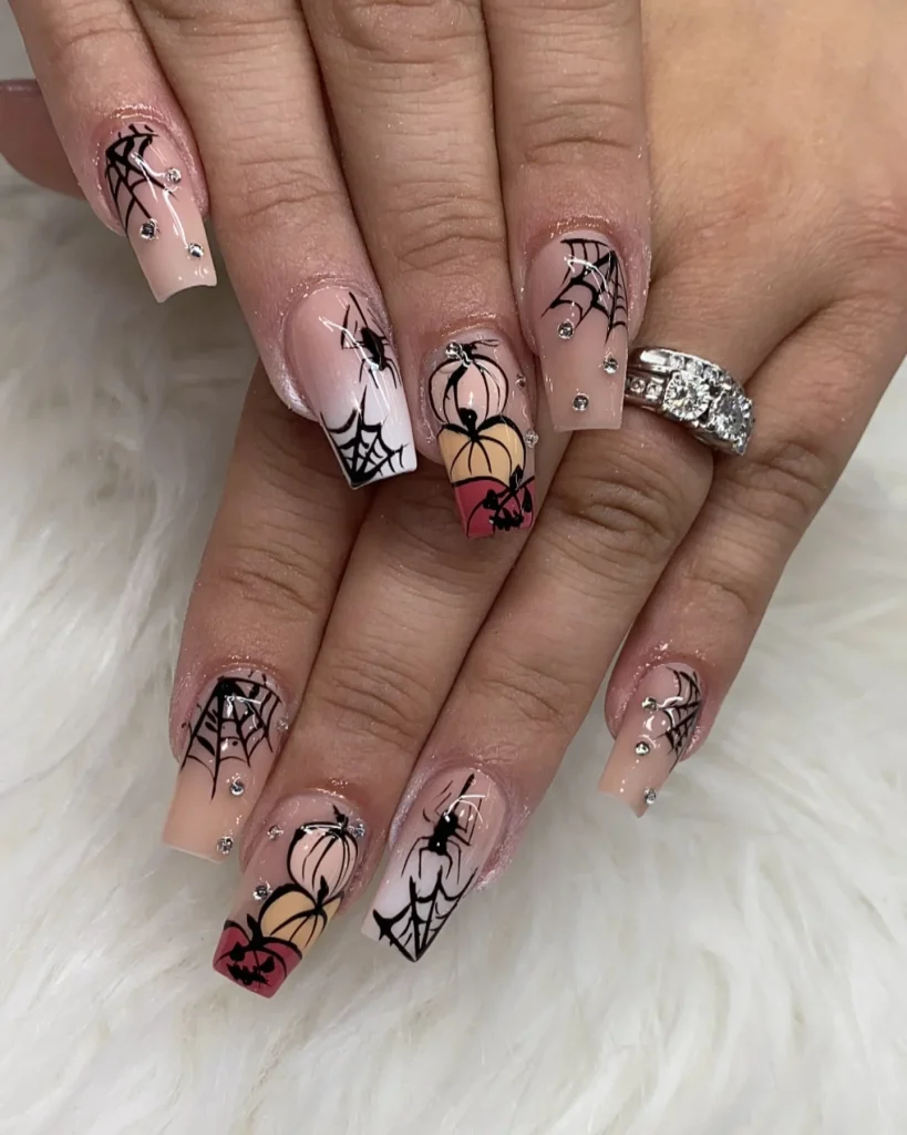 spider web skull Halloween nails nude — subtle glam halloween nail design 2026