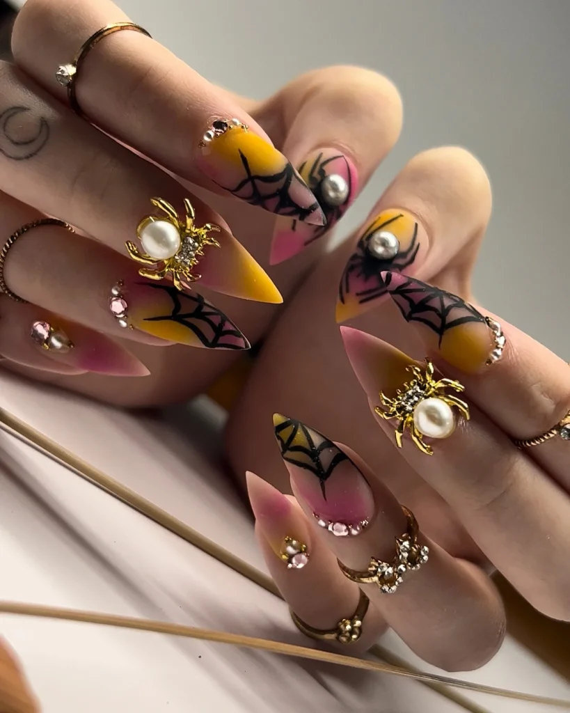 black base pearl spider Halloween nails nude gold charms — luxury halloween nail design 2026