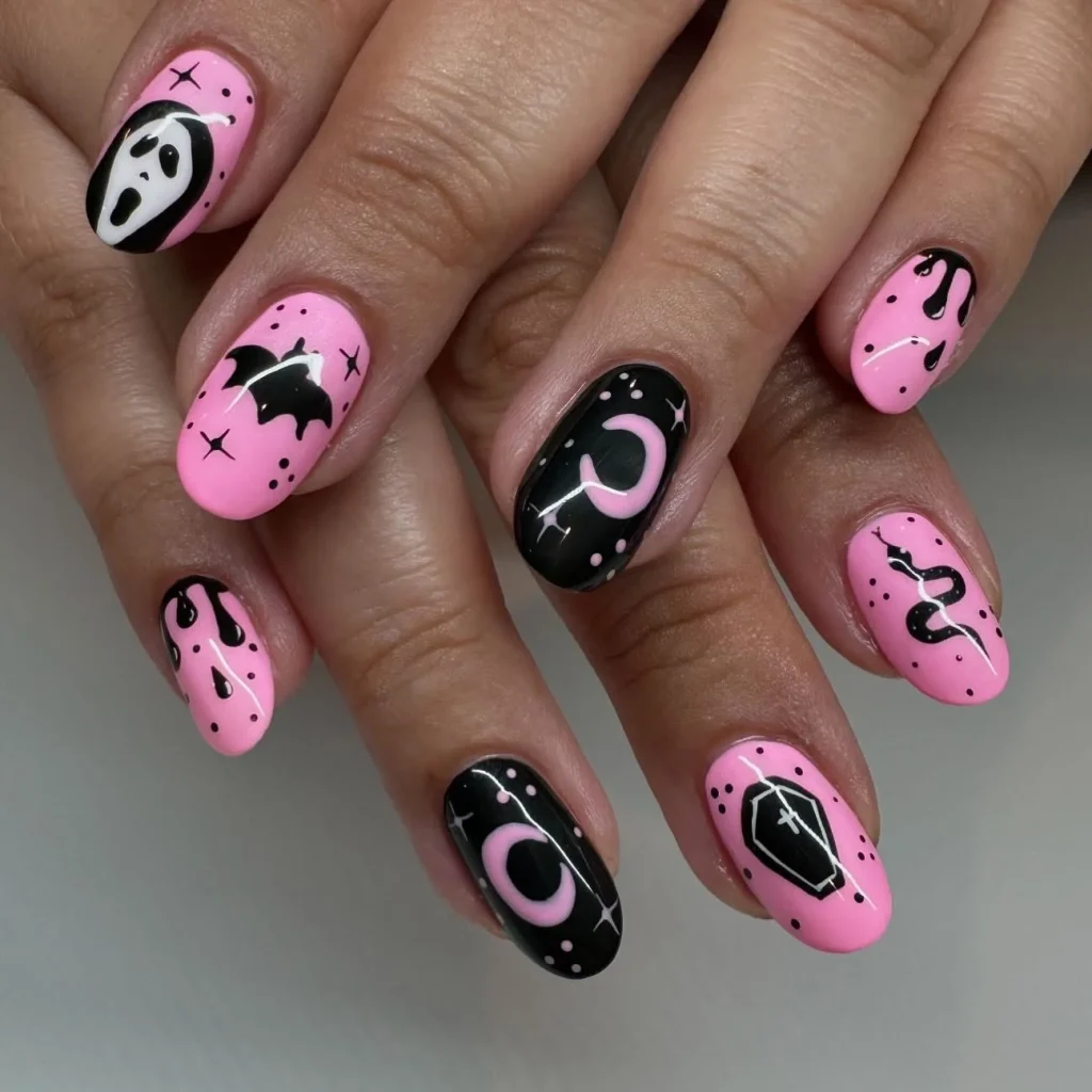 pink black Halloween bat moon nails — bold graphic halloween nail design 2026