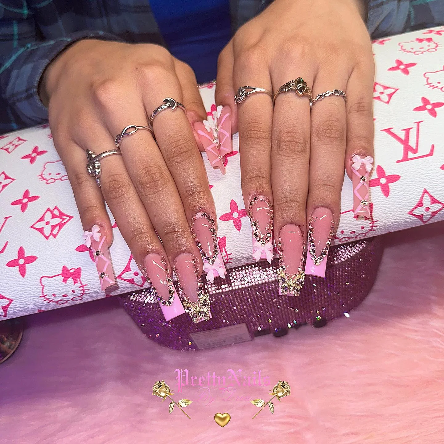 31 Nail Charm Ideas That Will Instantly Upgrade Your Nails in 2025 13 Pink long square nails with bow and butterfly rhinestone charms