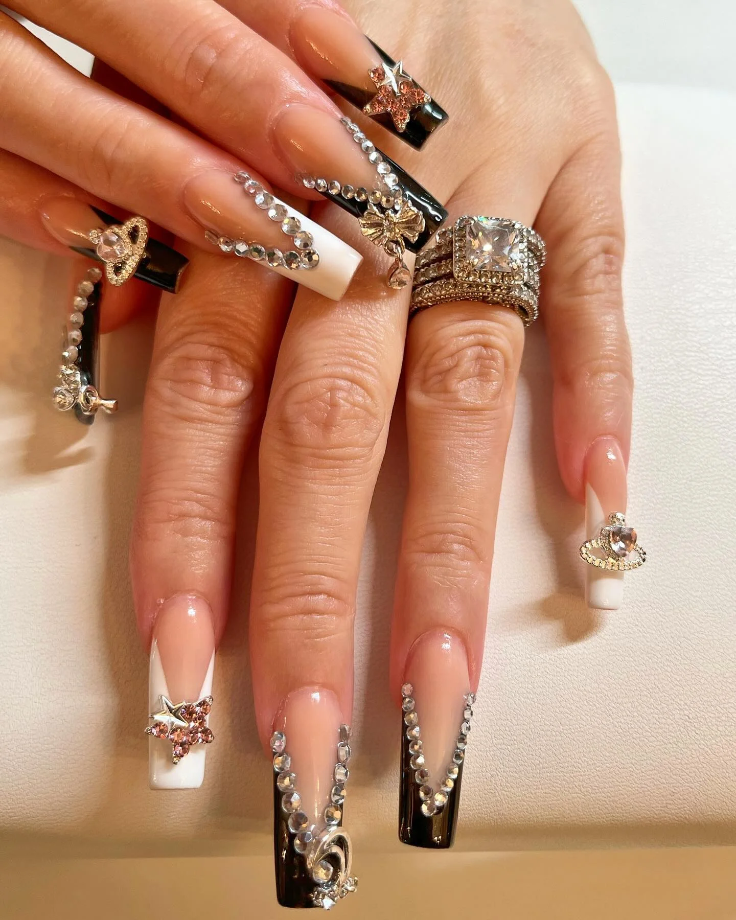 31 Nail Charm Ideas That Will Instantly Upgrade Your Nails in 2025 27 Long square nails with rhinestone chains, star charms and silver bow accents