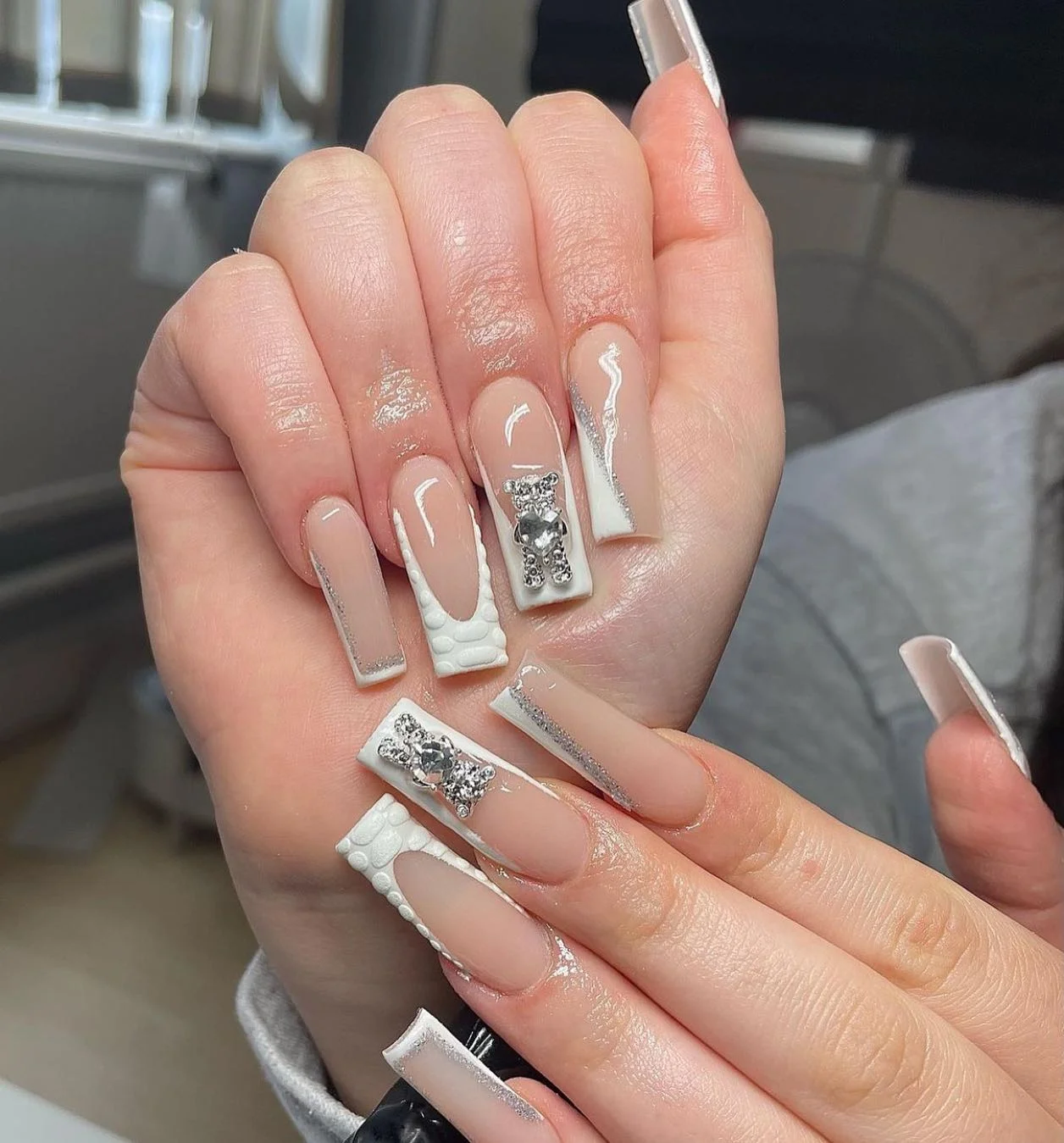 31 Nail Charm Ideas That Will Instantly Upgrade Your Nails in 2025 12 Long nude square nails with white bear rhinestone charm