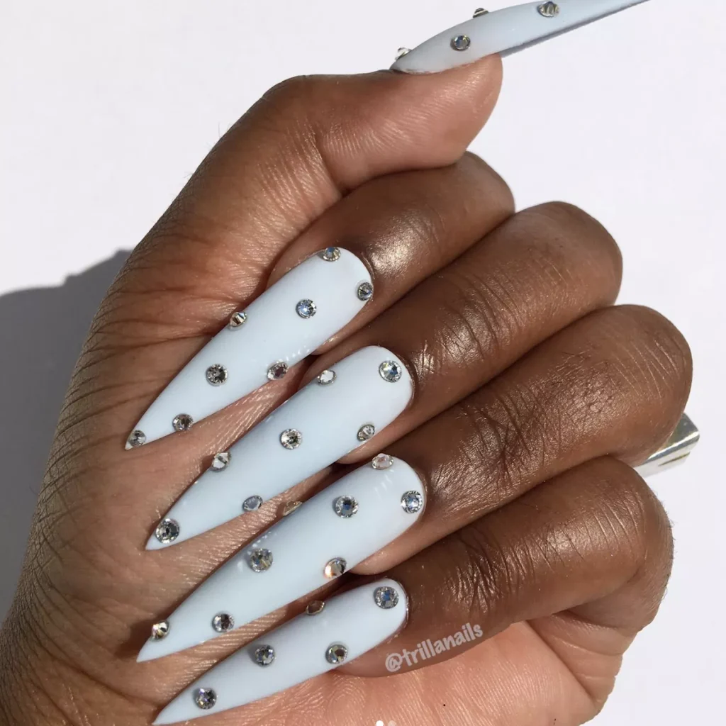 25+ Korean Winter Nail Ideas That Will Rule 2025 ❄️💅 10 Baby blue almond nails with crystals.