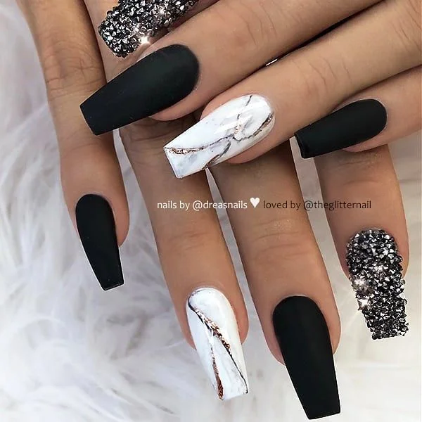 Black and White Nail Designs 2025: Chic Ideas for Every Occasion 12 Coffin-shaped black and white acrylic nails with matte black polish, marble effect accent nails, and glitter rhinestone tips for a bold luxury manicure.