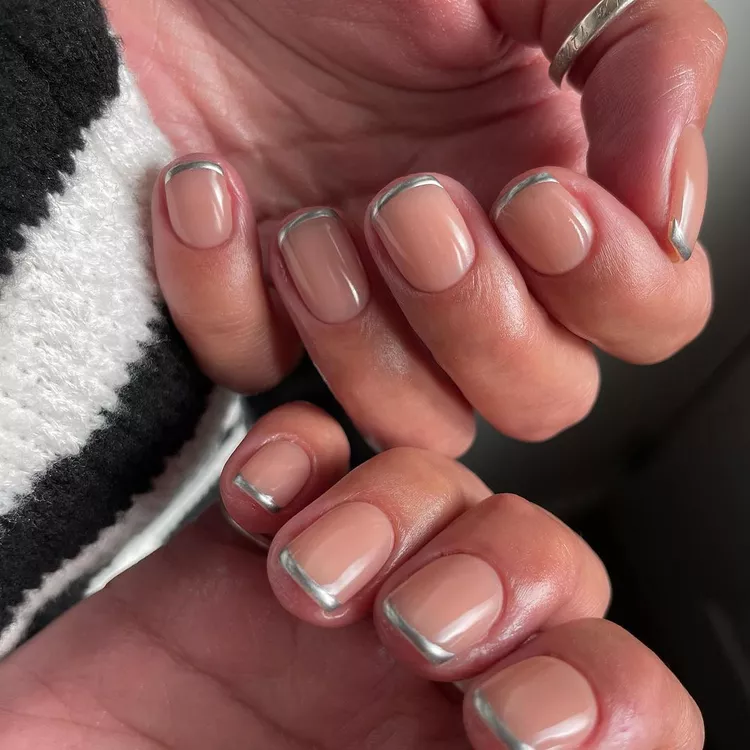 Nude November manicure with short natural nails and thin metallic silver French tips, minimalist nail design 2025