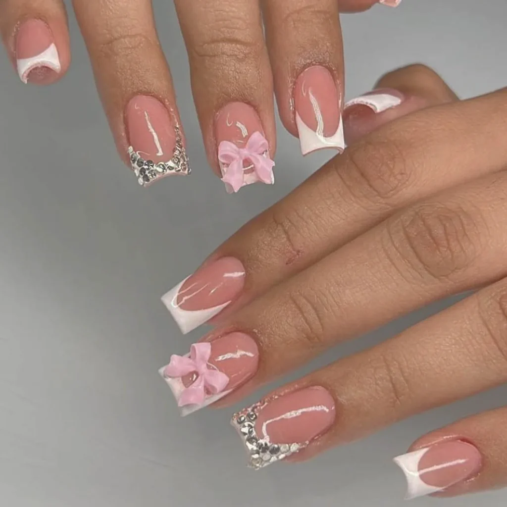 Pink French nails with bows and rhinestones