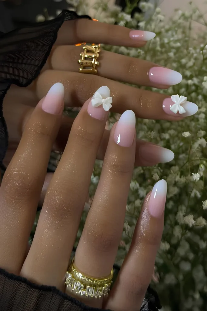 25+ Korean Winter Nail Ideas That Will Rule 2025 ❄️💅 32 Korean Winter Nail Ideas White to soft pink ombre nails with bows