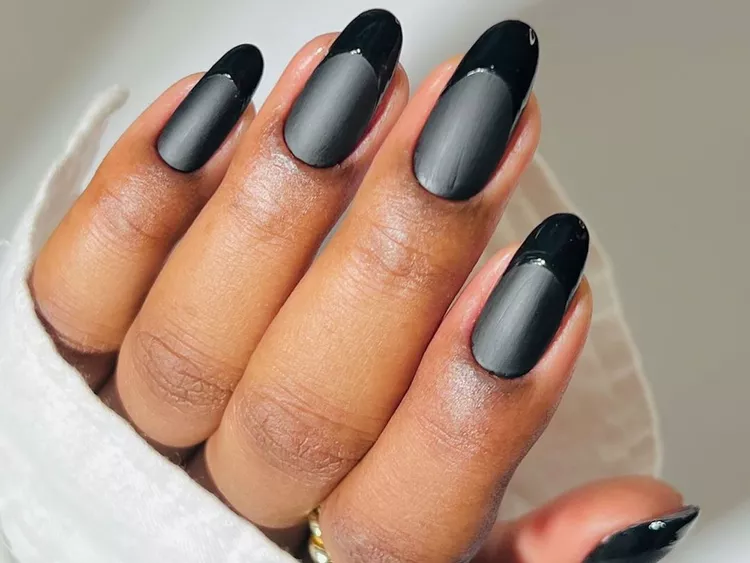 Matte grey nails with glossy black French tips on almond shape, modern two-tone manicure design 2025