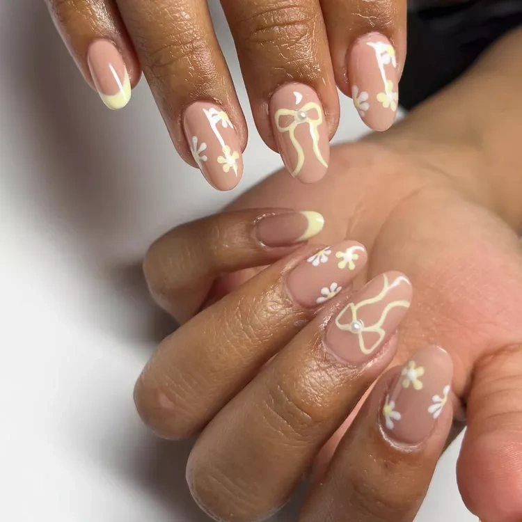 20 Beautiful Butter Yellow Nails Design You’ll Love This Summer 17 Abstract white swirl art on terracotta brown stiletto negative space nails