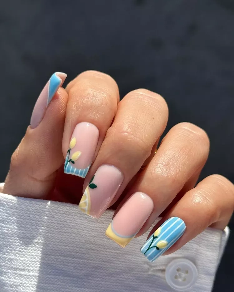 20 Beautiful Butter Yellow Nails Design You’ll Love This Summer 3 Summer lemon fruit and blue stripe French manicure nail art"