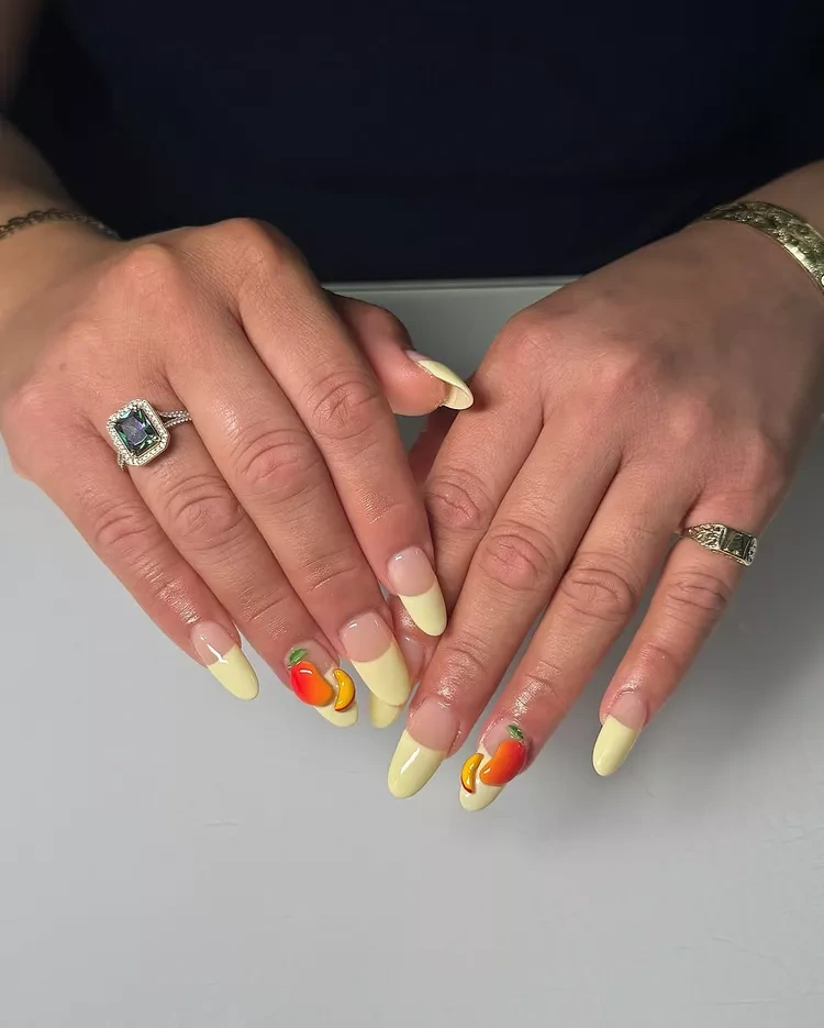 20 Beautiful Butter Yellow Nails Design You’ll Love This Summer 9 summer pastel yellow French tip almond nails with 3D peach fruit art