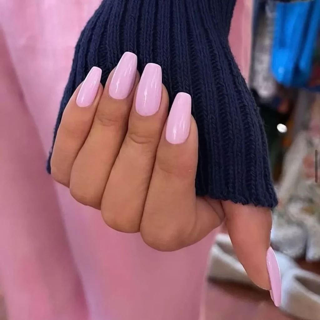 29 Simple Square Nail Designs for a Chic Summer Look (2025 Edition) 29 Light pink 'Barbiecore' solid color square nails on a hand wearing a navy sweater