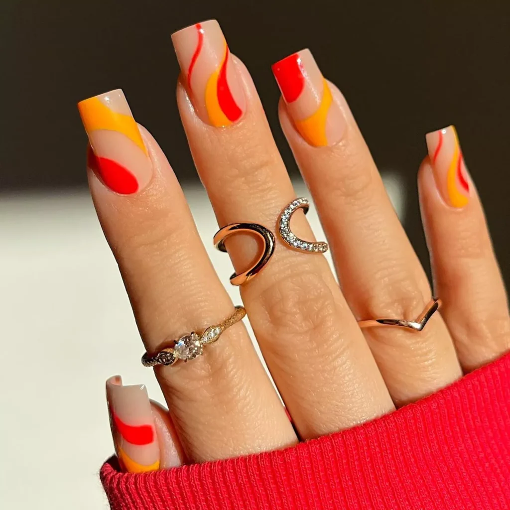 29 Simple Square Nail Designs for a Chic Summer Look (2025 Edition) 7 Long square abstract wave nails with nude base and bright red, yellow, and orange flame design