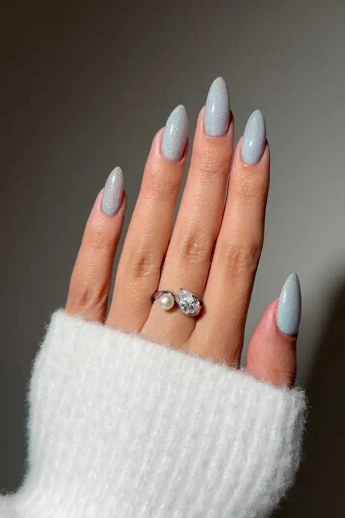 Short powder blue nails with a frosted matte finish and iridescent shimmer
