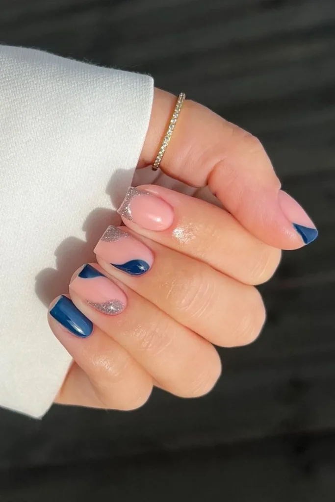 Minimalist icy light blue negative space design with a single white dot accent on short rounded nails