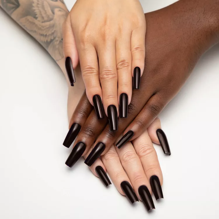 32+ Best Nail Colors for Dark Skin That Look Absolutely Stunning 27 Two hands, one light-skinned and one deep brown-skinned, with extra-long, glossy dark brown square-tipped nails. The color is a rich, moody chocolate brown, perfect for fall.