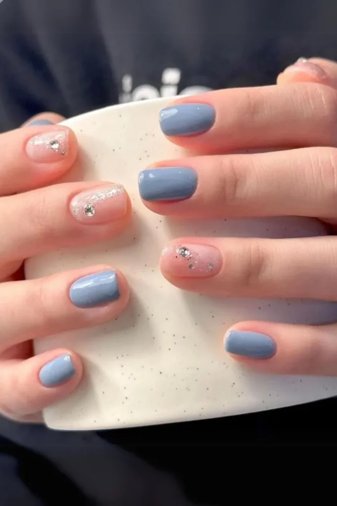 Shimmering light blue polish with a moonstone cat-eye effect and soft sparkle on short square nails