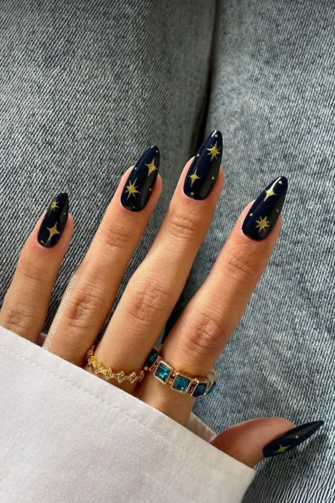 Chrome silver French tips on an almond shape with delicate white and silver star decals