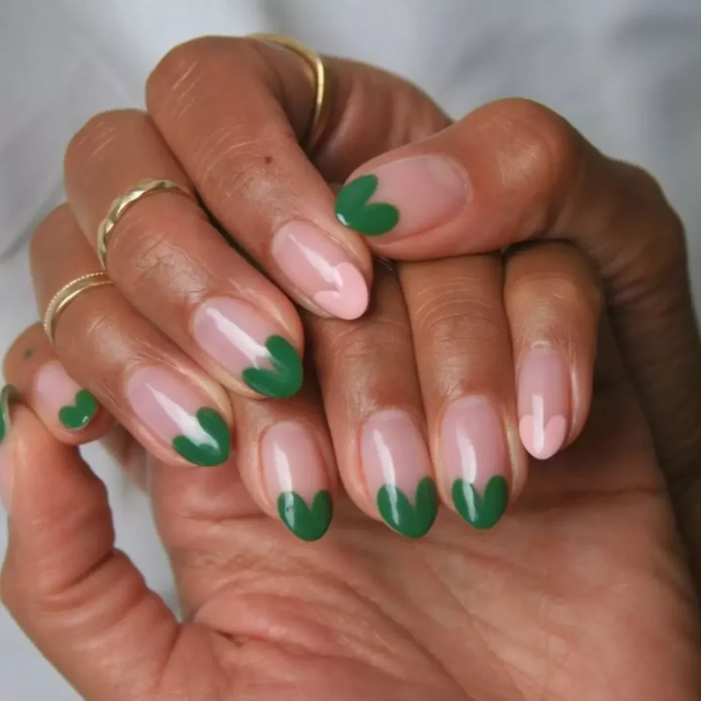 Red micro heart French tips on a sheer pink base for a subtle romantic manicure