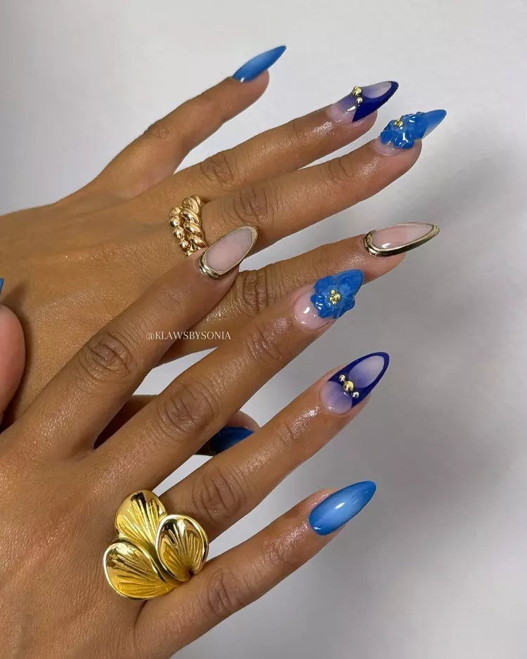 30 Stunning Dark Blue Nail Designs for a Denim-Inspired Summer Look 10 Bright blue 3D floral summer nails with mixed designs including stiletto French tips, blue flower accents, and gold studs. A creative and trendy summer manicure.