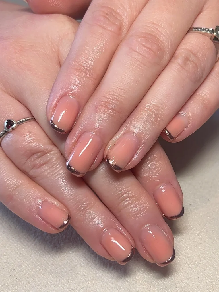 15 Short Nail Ideas for Women Over 60 Elegant, Easy-to-Maintain Designs That Flatter Mature Hands (2026) 14 rose gold tips short nails over 60 — modern warm metallic mature manicure